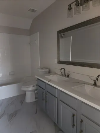 a bathroom with a sink a toilet and a bathtub