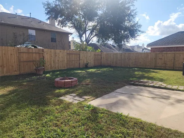 a view of a backyard with a tree