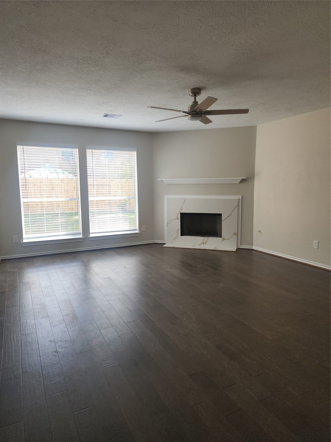 10614 Acacia Forest Trail Houston, TX 77089 - Photo 6 of 27 an empty room with wooden floor fireplace and windows