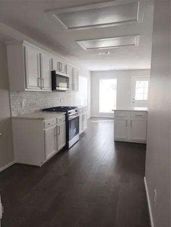 a kitchen with stainless steel appliances granite countertop a stove and a sink