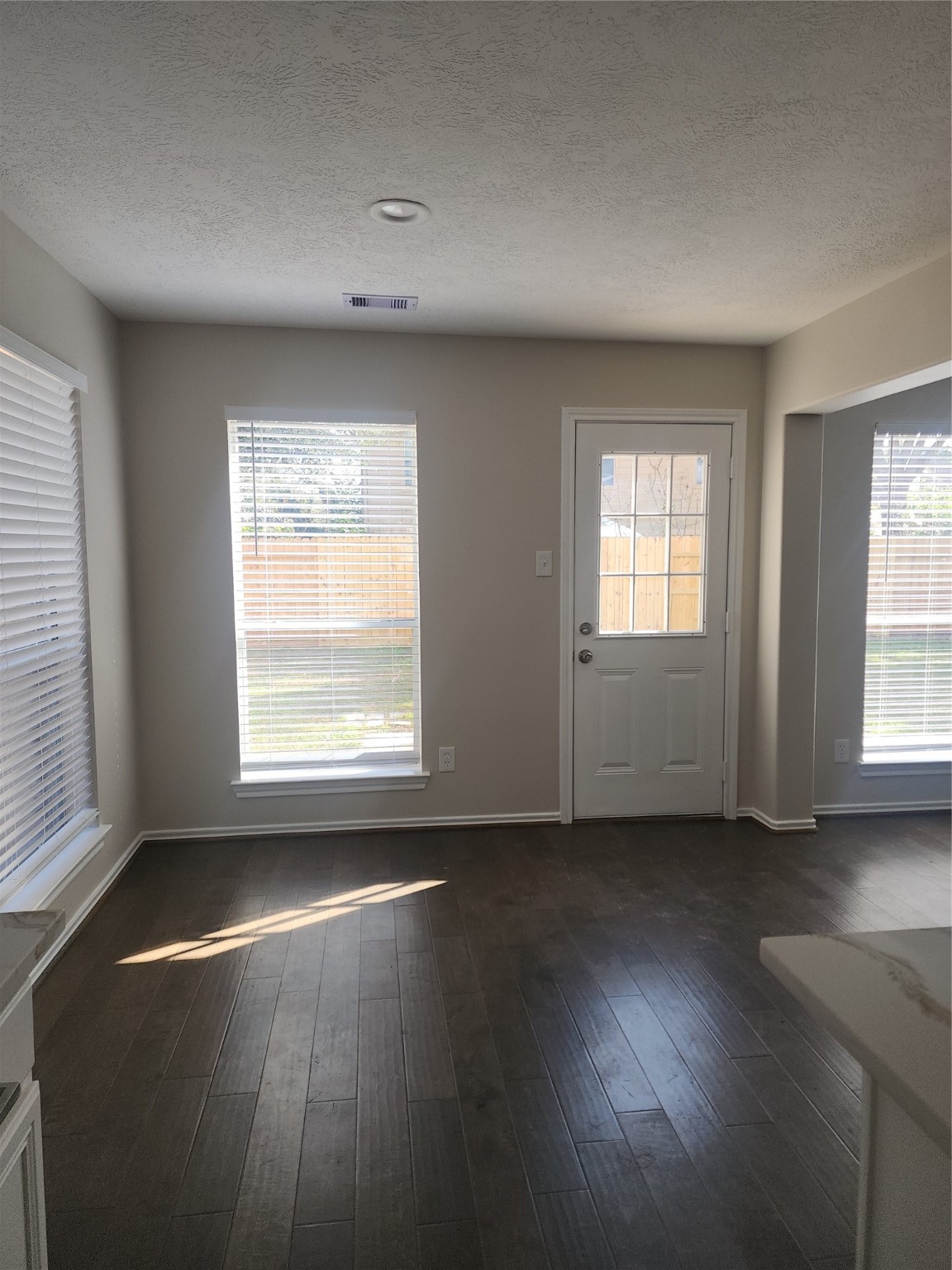 10614 Acacia Forest Trail Houston, TX 77089 - Photo 10 of 27 a view of an empty room with wooden floor and a window