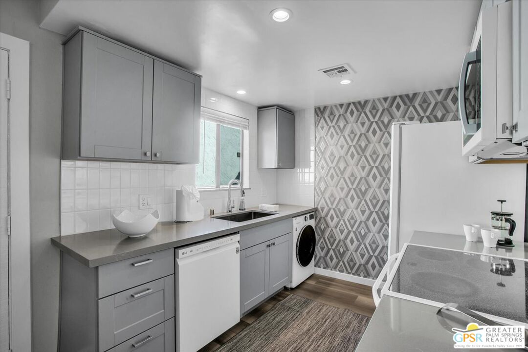 1050 Ramon Road, Unit 116 Palm Springs, CA 92264 - Photo 8 of 34 a kitchen with a sink stove and refrigerator