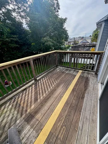 a view of balcony with wooden floor