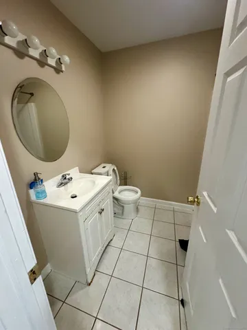 a bathroom with a sink a toilet and a mirror