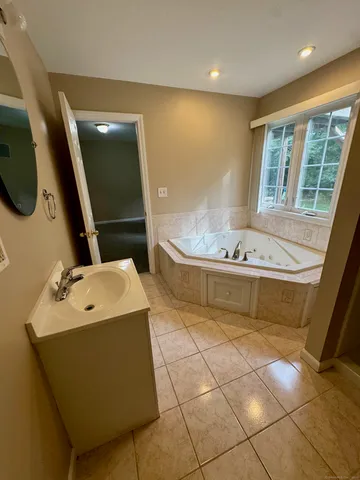 a bathroom with a sink a toilet and mirror