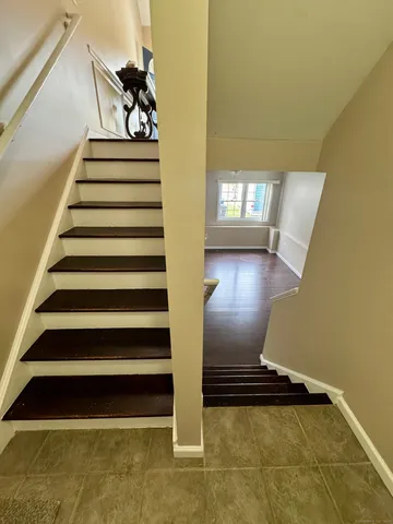a view of entryway and hall with wooden floor