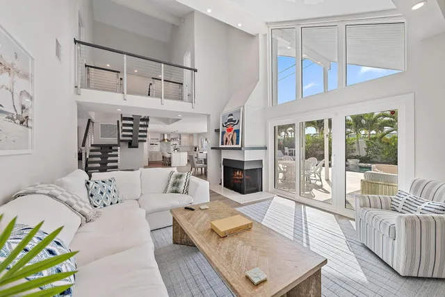 an aerial view of a house with a yard and a large tree