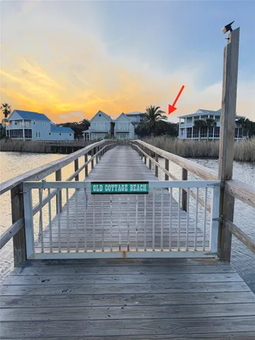 a view of balcony with two chairs and wooden fence