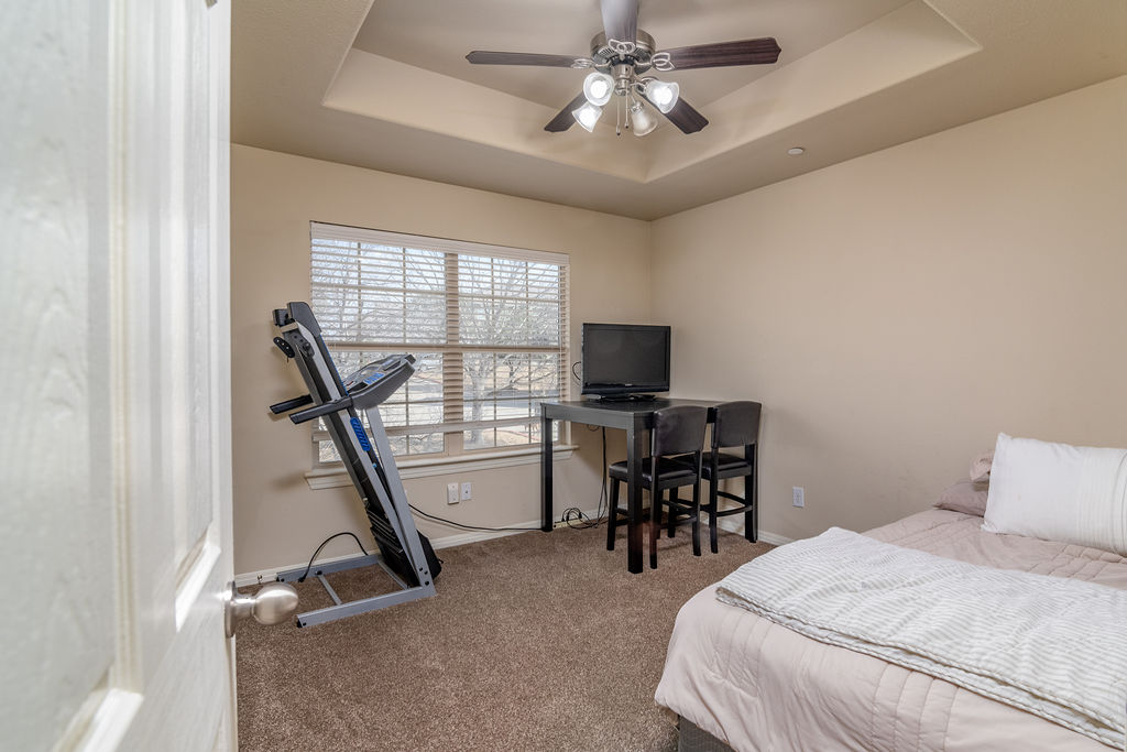 3101 Davis Lane, Unit 8402 Austin, TX 78748 - Photo 11 of 24 a bedroom with furniture and a flat screen tv