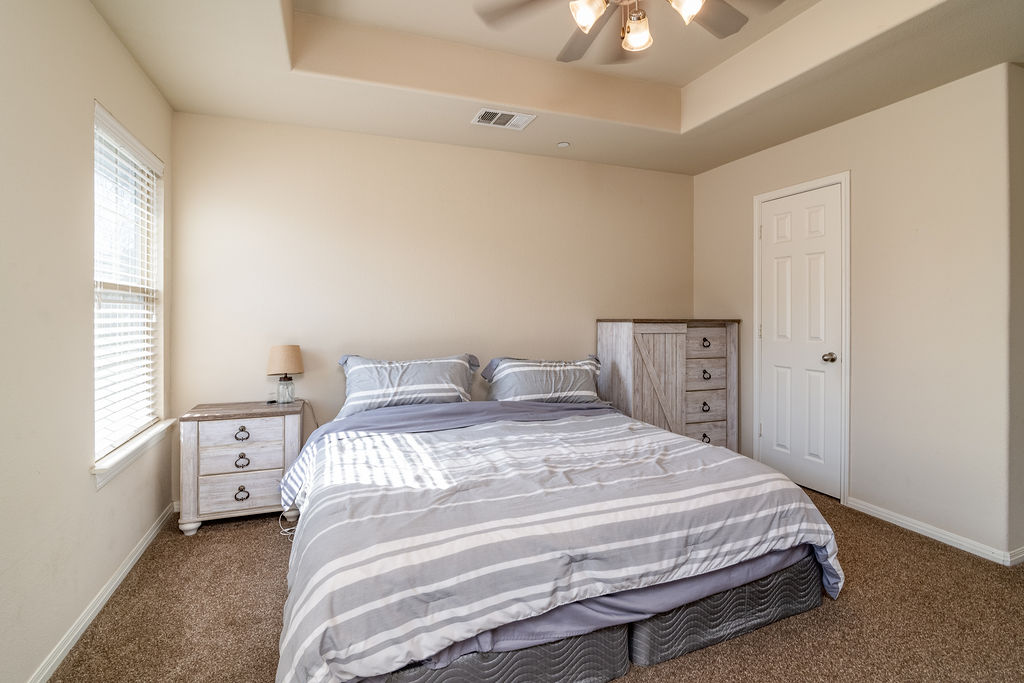 3101 Davis Lane, Unit 8402 Austin, TX 78748 - Photo 16 of 24 a spacious bedroom with a bed and a window