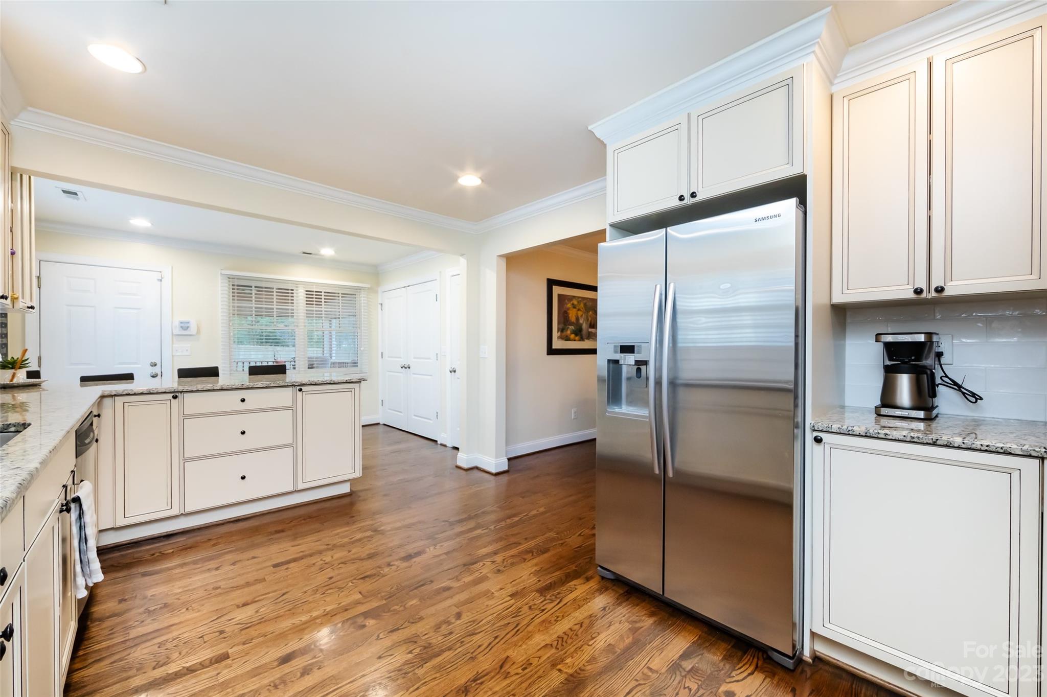4341 Applegate Road Charlotte, NC 28209 - Photo 15 of 39 a kitchen with white cabinets and stainless steel appliances