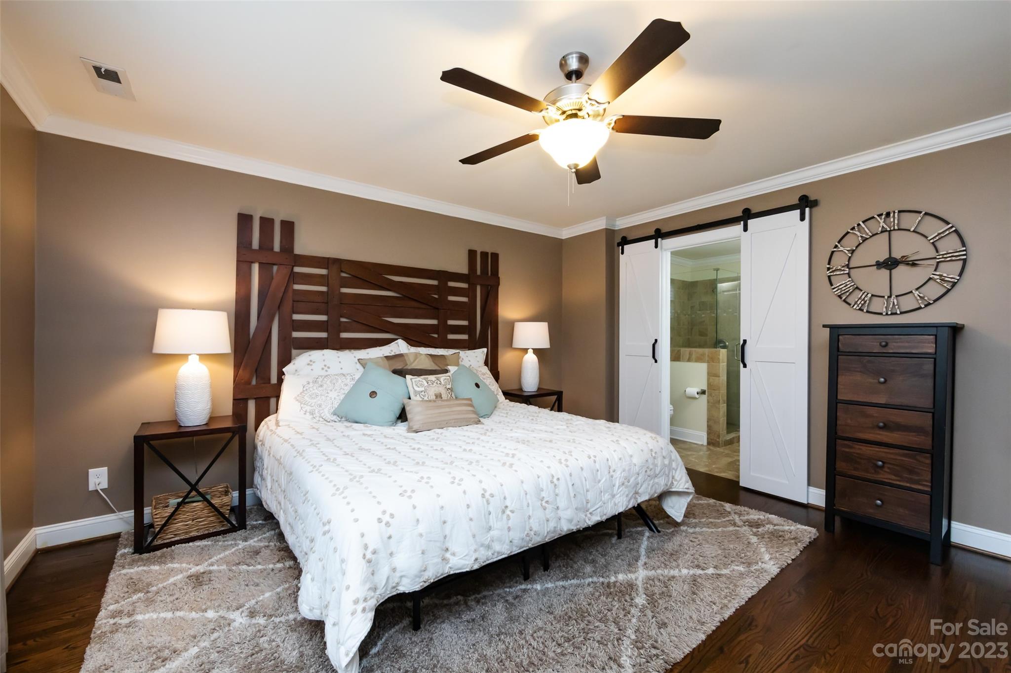 4341 Applegate Road Charlotte, NC 28209 - Photo 23 of 39 a bedroom with a large bed and a chandelier