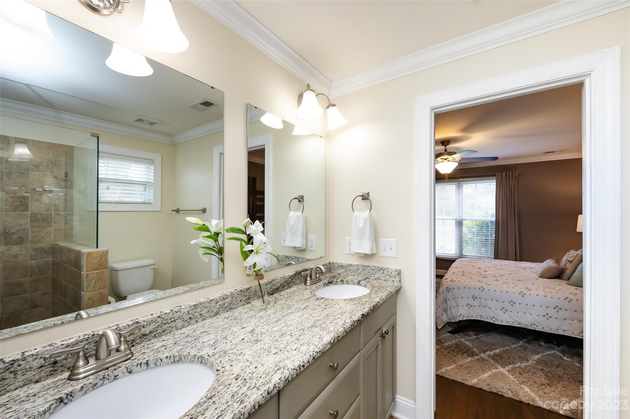 4341 Applegate Road Charlotte, NC 28209 - Photo 26 of 39 a en suite bathroom with a granite countertop sink and a mirror