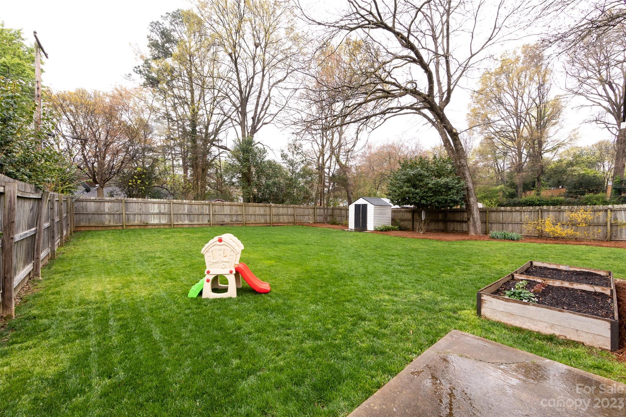 4341 Applegate Road Charlotte, NC 28209 - Photo 34 of 39 a green field with lots of trees in the background