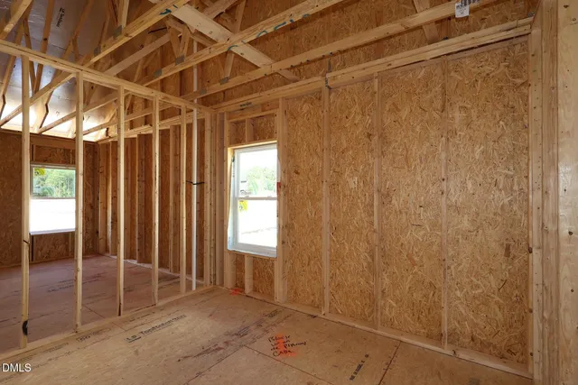 a view of an empty room with floor to ceiling windows