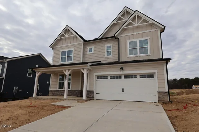 a front view of a house with a garage