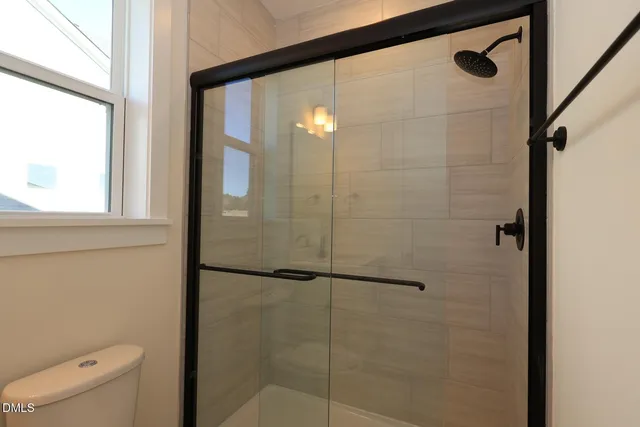 a bathroom with a shower and a toilet