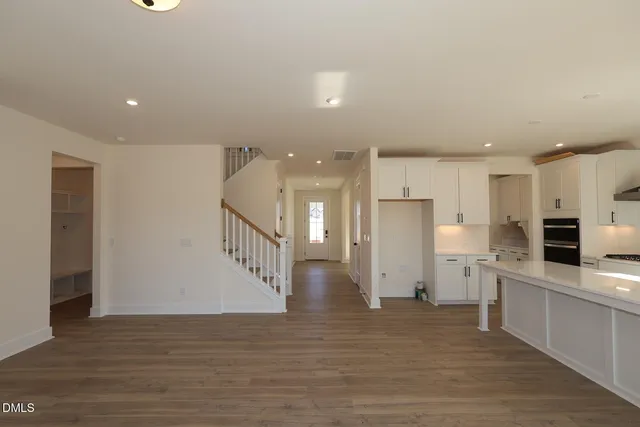 a view of a kitchen with a refrigerator and a microwave