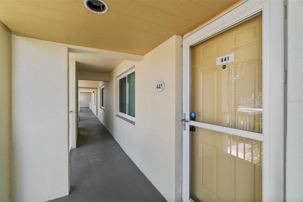 433 Cerromar Lane, Unit 441 Venice, FL 34293 - Photo 2 of 65 a view of a hallway with a glass door