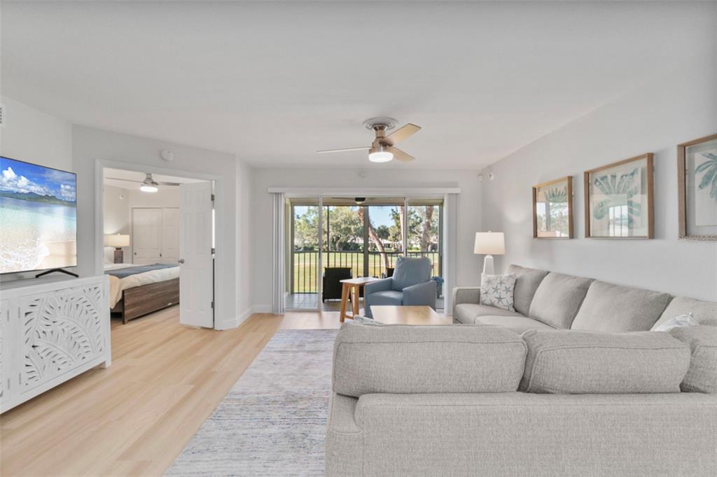 433 Cerromar Lane, Unit 441 Venice, FL 34293 - Photo 24 of 65 a living room with furniture and a large window