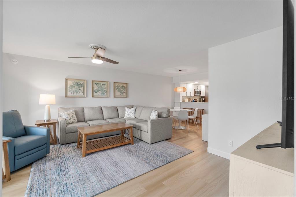 433 Cerromar Lane, Unit 441 Venice, FL 34293 - Photo 25 of 65 a living room with furniture and a flat screen tv