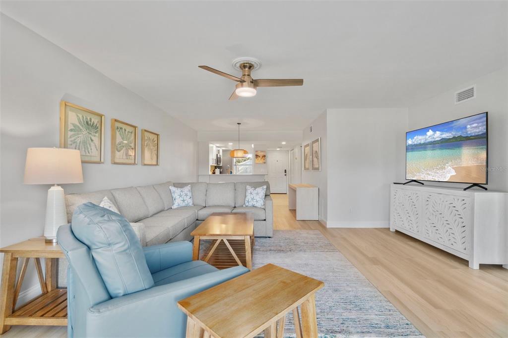 433 Cerromar Lane, Unit 441 Venice, FL 34293 - Photo 28 of 65 a living room with furniture and a flat screen tv