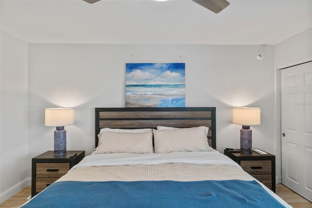 433 Cerromar Lane, Unit 441 Venice, FL 34293 - Photo 31 of 65 a bedroom with a bed and a night stand