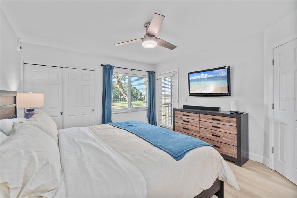 433 Cerromar Lane, Unit 441 Venice, FL 34293 - Photo 37 of 65 a bedroom with a bed and a flat screen tv
