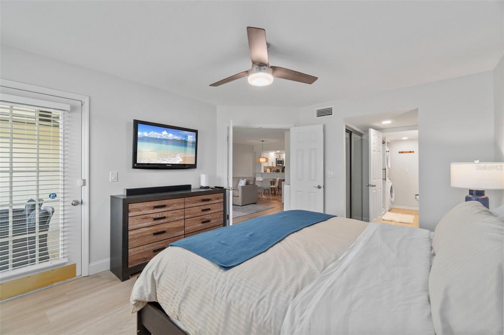433 Cerromar Lane, Unit 441 Venice, FL 34293 - Photo 39 of 65 a bedroom with a bed dresser and a flat tv screen