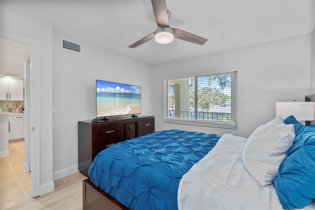 433 Cerromar Lane, Unit 441 Venice, FL 34293 - Photo 44 of 65 a bedroom with a bed and a window