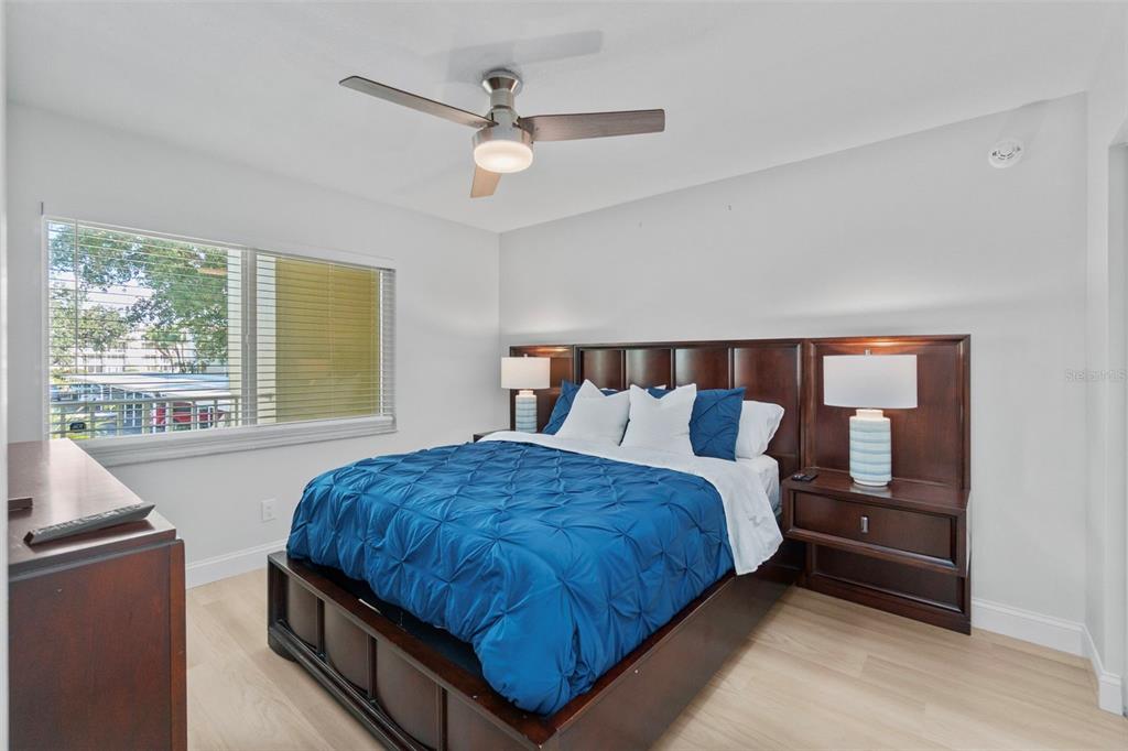 433 Cerromar Lane, Unit 441 Venice, FL 34293 - Photo 45 of 65 a bedroom with a large bed and a large window