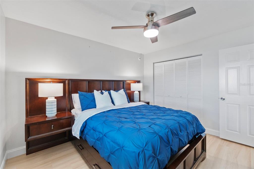 433 Cerromar Lane, Unit 441 Venice, FL 34293 - Photo 48 of 65 a large bed sitting in a bedroom next to a cabinet