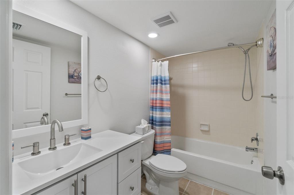 433 Cerromar Lane, Unit 441 Venice, FL 34293 - Photo 49 of 65 a bathroom with a sink toilet and shower