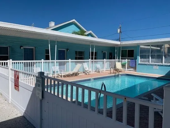 a front view of house with deck and outdoor seating