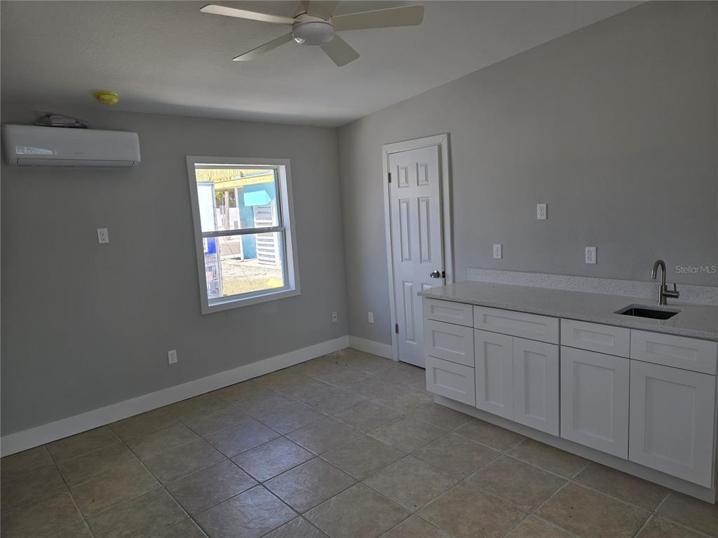 13343 Gulf Boulevard, Unit A1 St. Petersburg, FL 33708 - Photo 3 of 8 an empty room with windows and fan