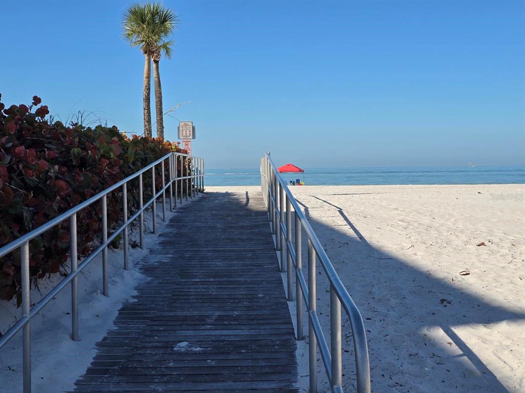 13343 Gulf Boulevard, Unit A1 St. Petersburg, FL 33708 - Photo 7 of 8 a view of balcony with wooden floor and a potted plant
