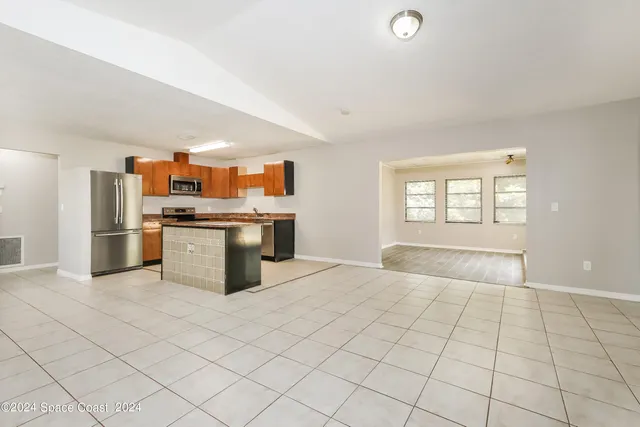 a view of a kitchen with a sink and a window