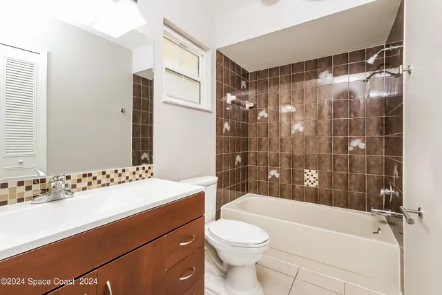 an empty room with white walls and tiles