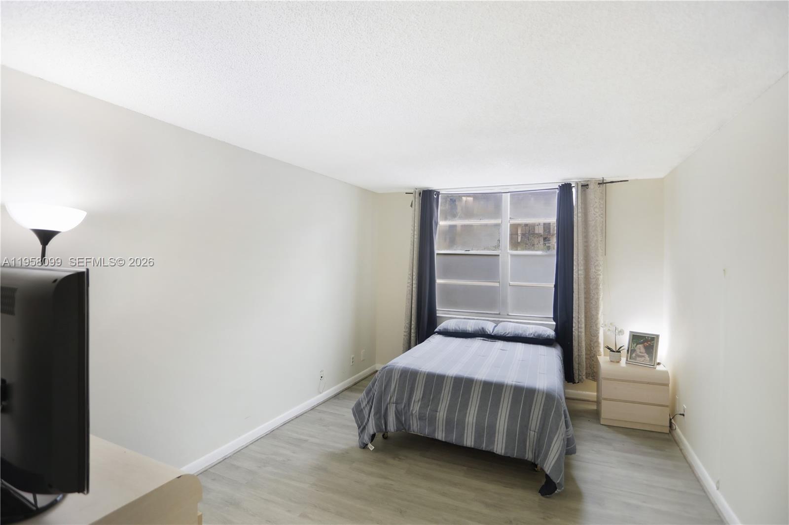 6600 Cypress Road, Unit 105 Plantation, FL 33317 - Photo 12 of 51 a bedroom with a bed and a window