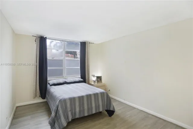 a bedroom with a bed and a wall painting