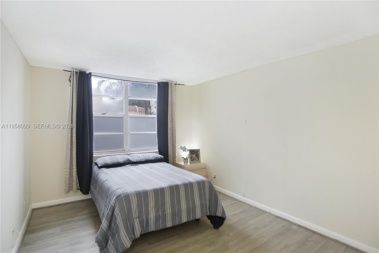 6600 Cypress Road, Unit 105 Plantation, FL 33317 - Photo 14 of 51 a bedroom with a bed and a wall painting