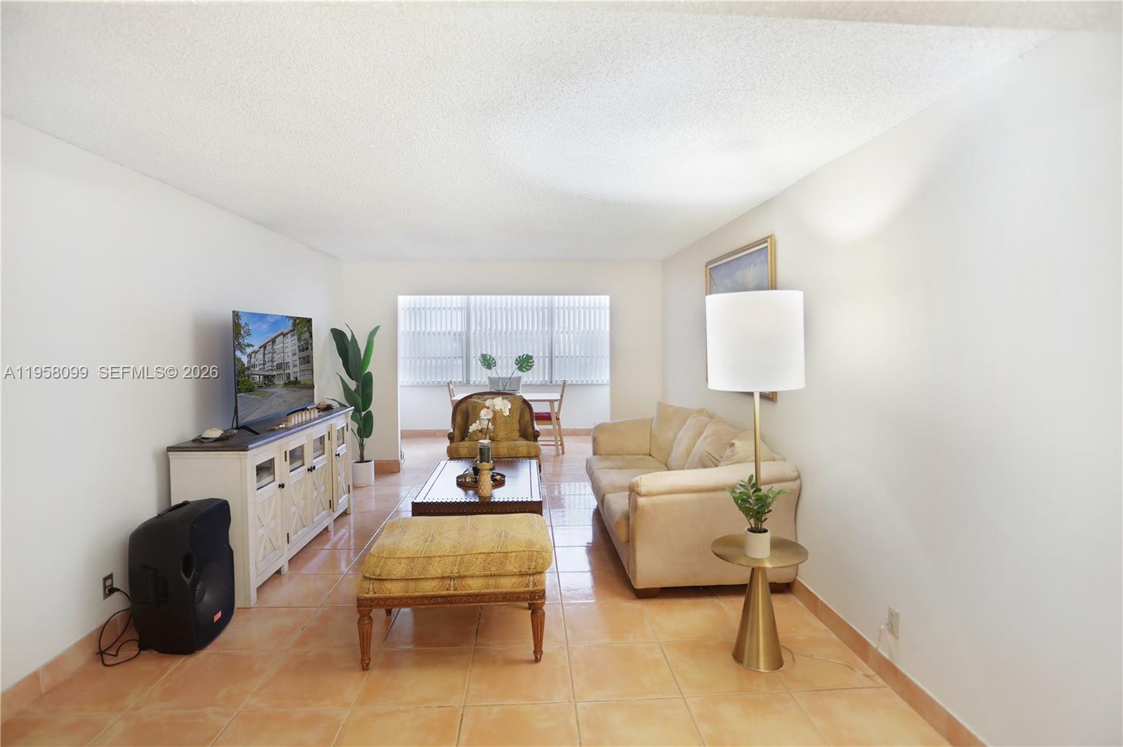 6600 Cypress Road, Unit 105 Plantation, FL 33317 - Photo 23 of 51 a living room with furniture and a flat screen tv