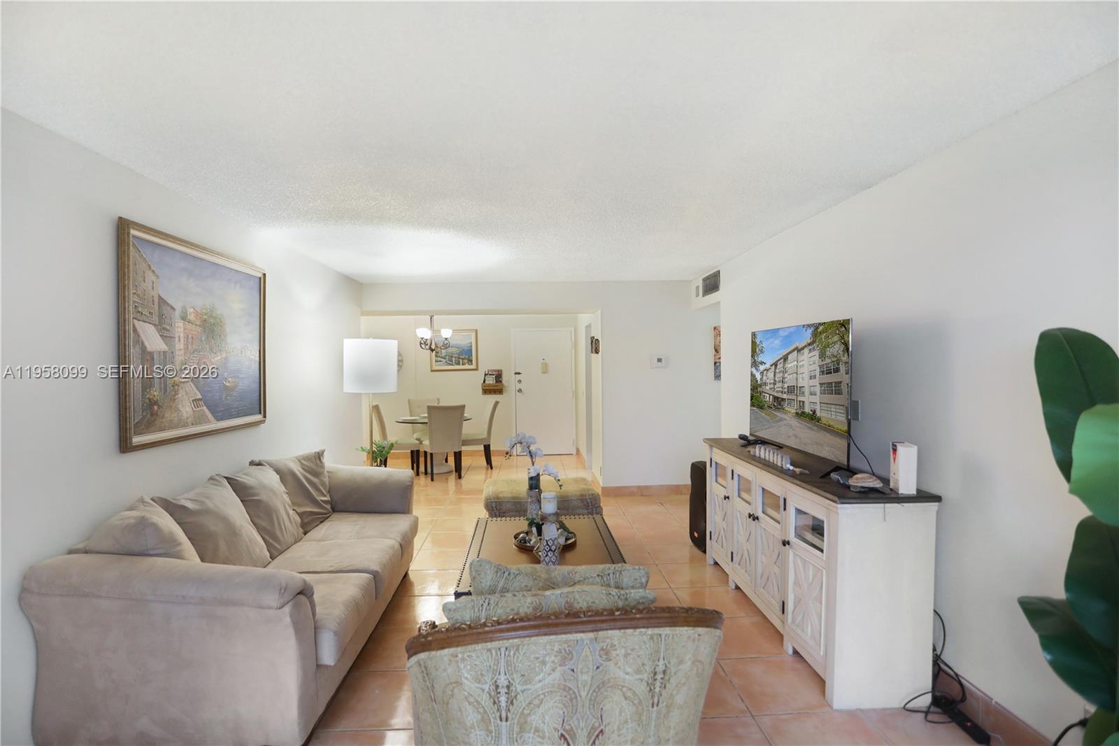 6600 Cypress Road, Unit 105 Plantation, FL 33317 - Photo 28 of 51 a living room with furniture and a flat screen tv