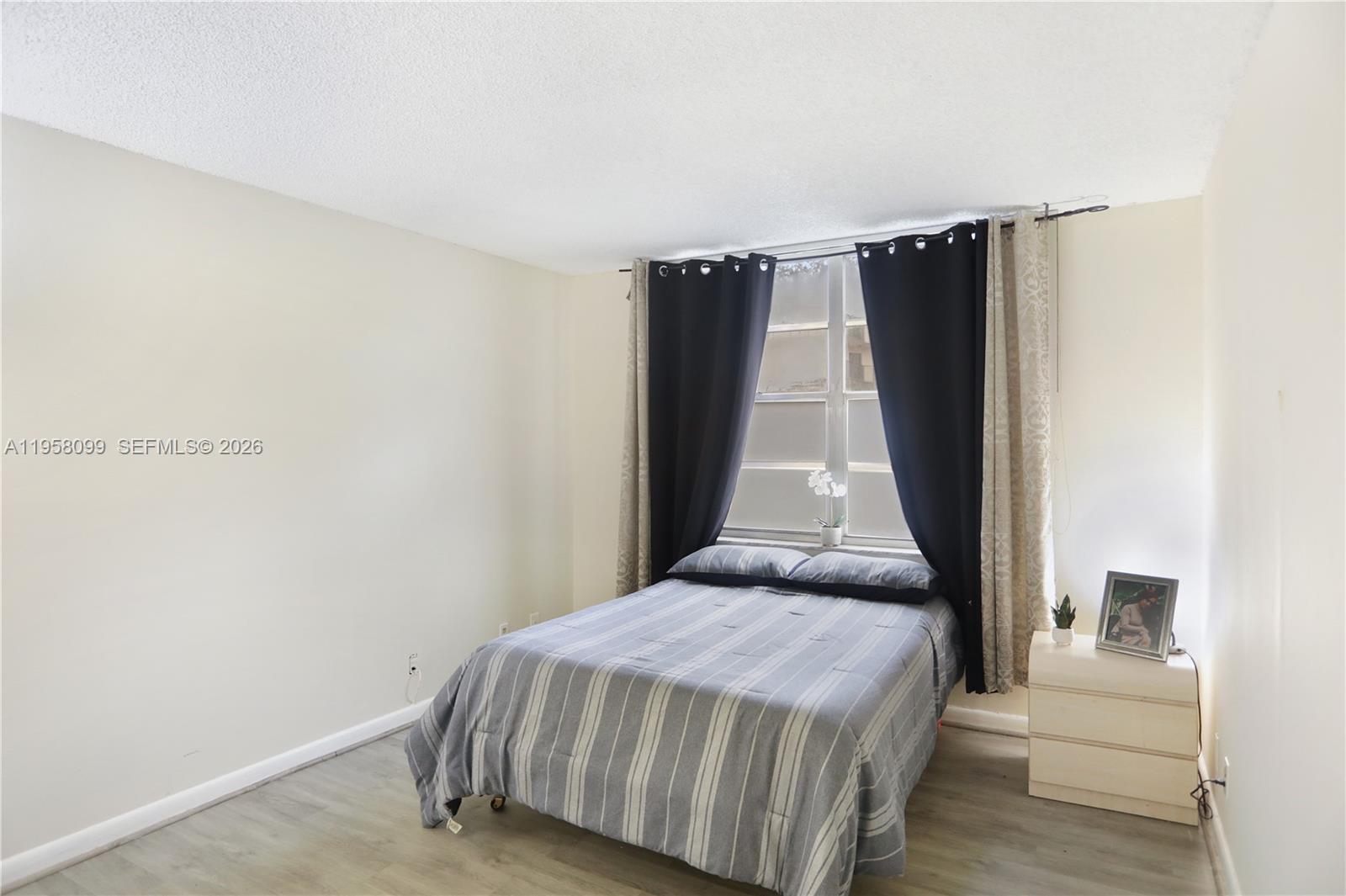 6600 Cypress Road, Unit 105 Plantation, FL 33317 - Photo 33 of 51 a bedroom with a bed and a black wall painting