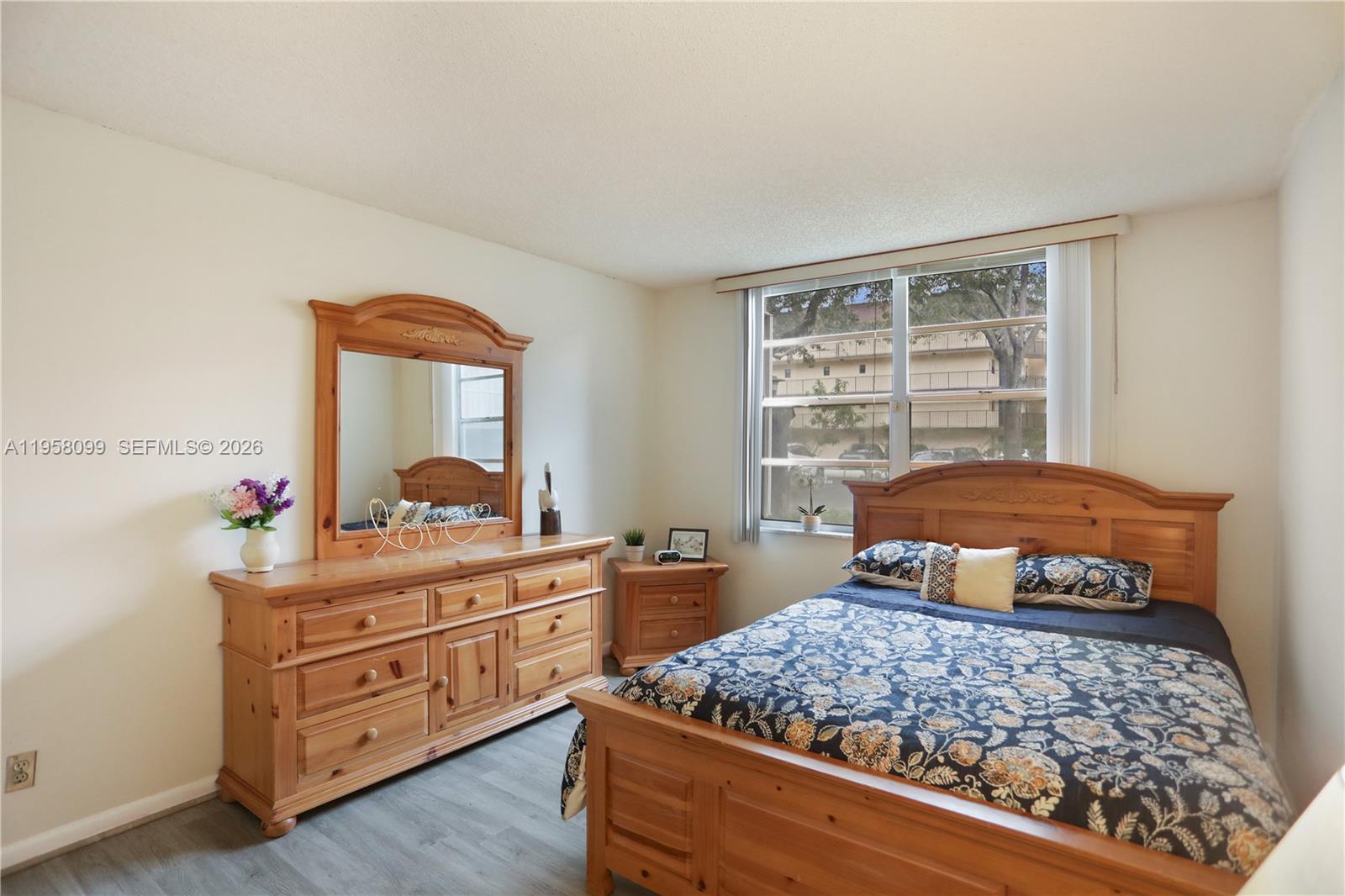 6600 Cypress Road, Unit 105 Plantation, FL 33317 - Photo 38 of 51 a bedroom with a bed and a dresser