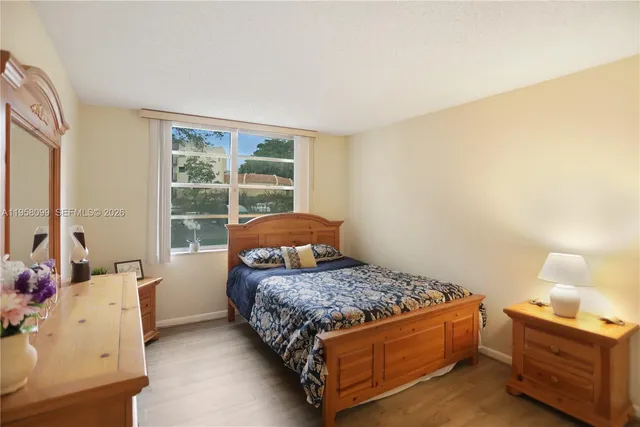 a bedroom with a bed and windows