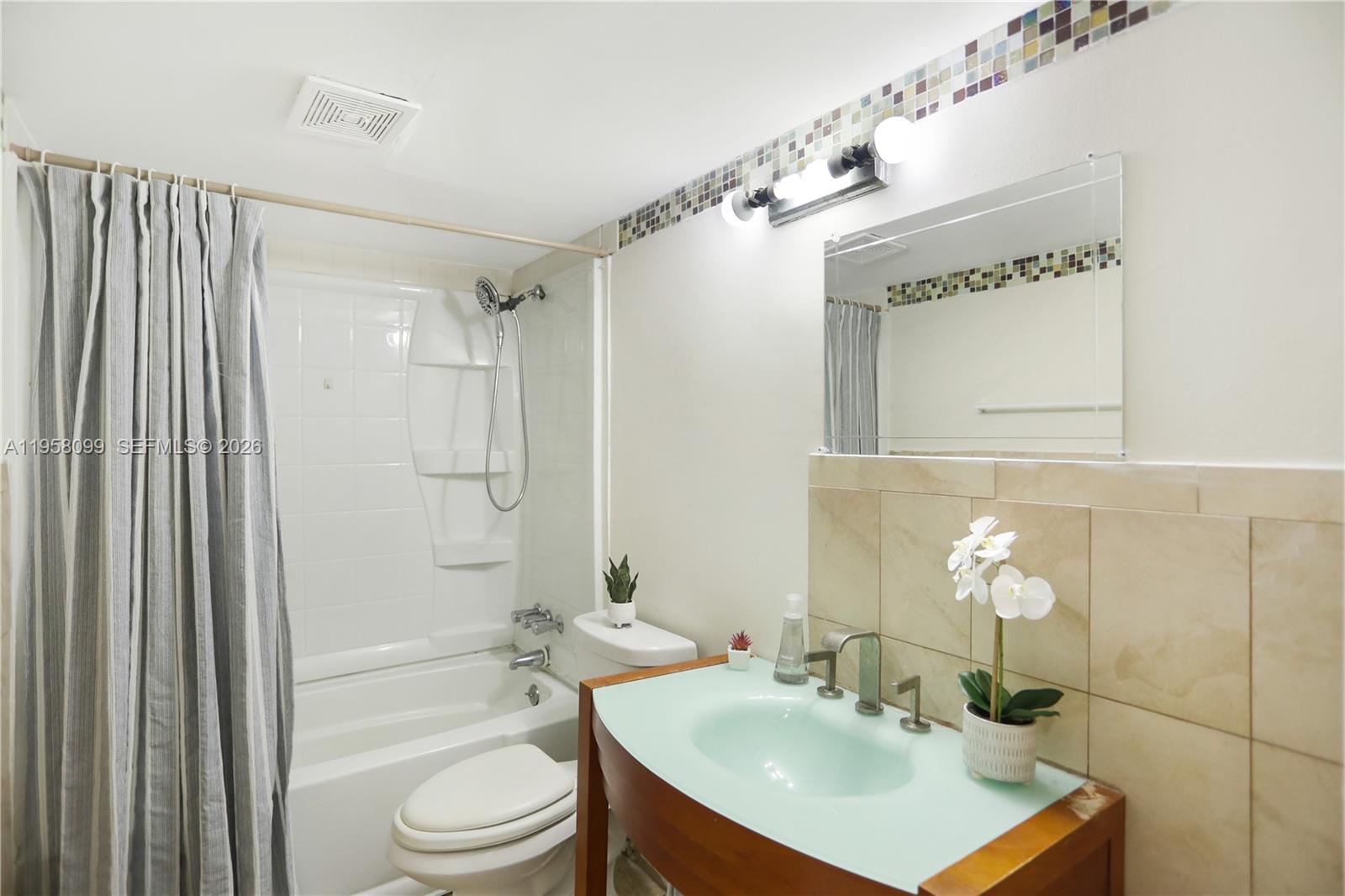 6600 Cypress Road, Unit 105 Plantation, FL 33317 - Photo 44 of 51 a bathroom with a sink toilet a shower and a mirror