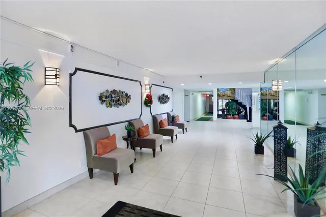 a living room with furniture and a potted plant