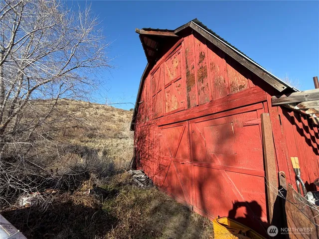 a view of a yard with wooden fence