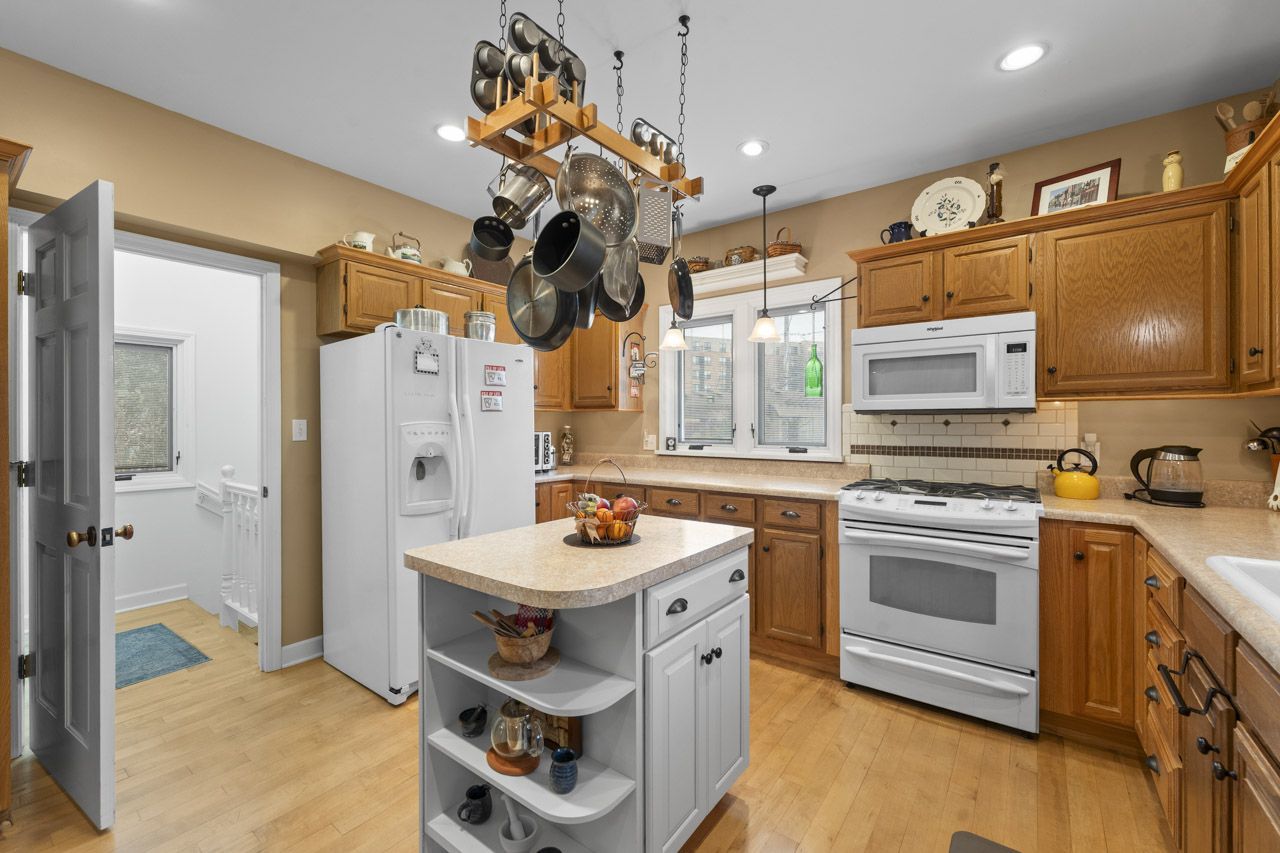 114 South Elm Street Mount Prospect, IL 60056 - Photo 16 of 44 a kitchen with stainless steel appliances granite countertop a sink a stove and a refrigerator